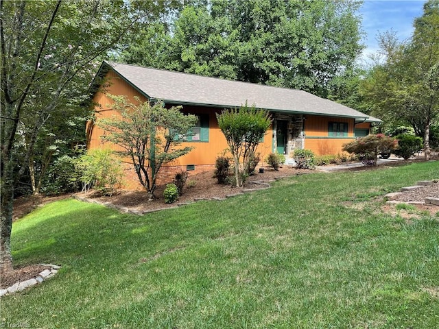 ranch-style house featuring roof with shingles, crawl space, and a front yard