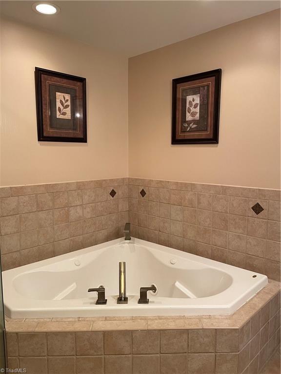 bathroom featuring tiled bath