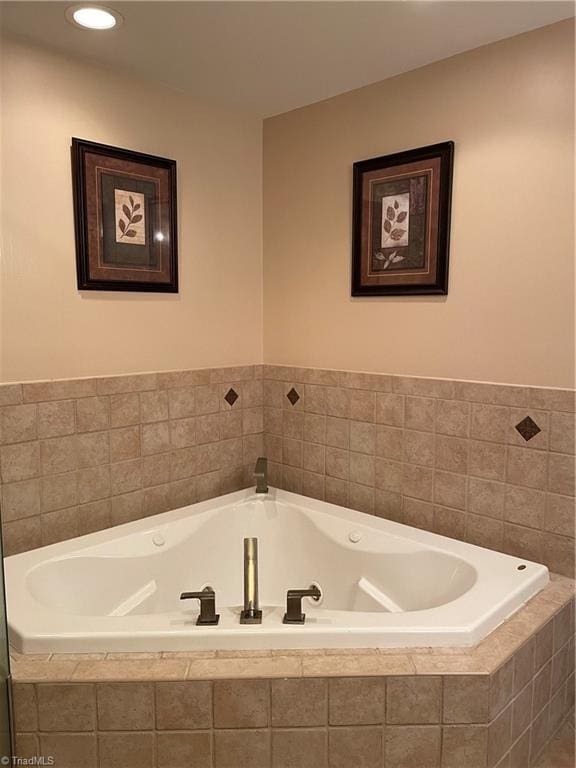 full bathroom with a jetted tub