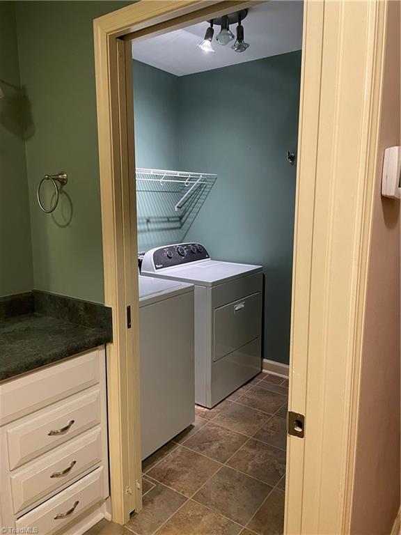 washroom featuring laundry area and separate washer and dryer