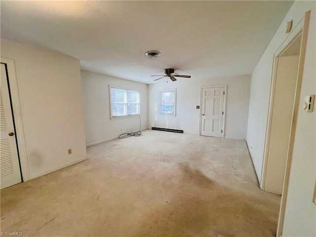 carpeted empty room with ceiling fan and a baseboard radiator