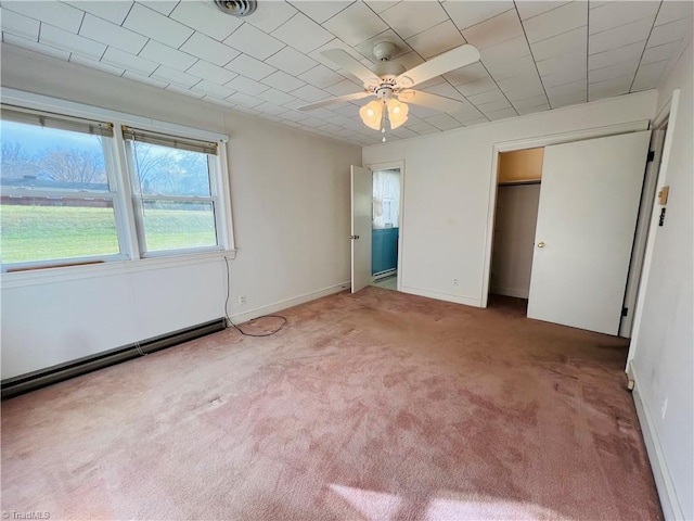 unfurnished bedroom with ceiling fan, carpet floors, and baseboard heating