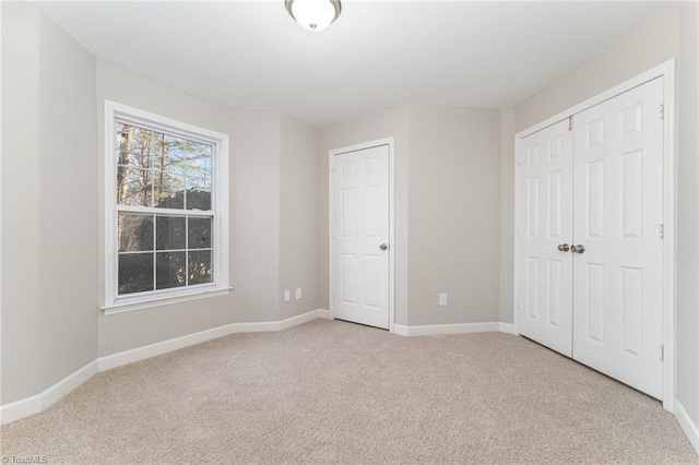 unfurnished bedroom featuring light carpet