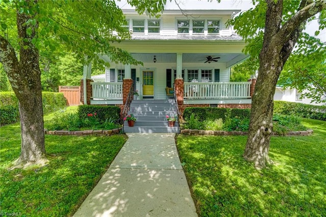 view of front of home featuring a porch, a ceiling fan, and a front yard
