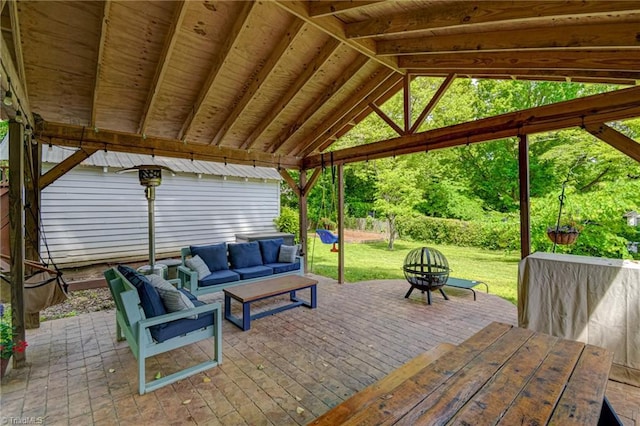view of patio with an outdoor living space with a fire pit and a deck