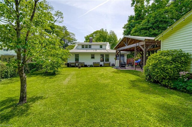 back of house featuring a patio, a yard, and a gazebo