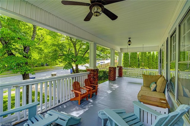 deck featuring covered porch and a ceiling fan
