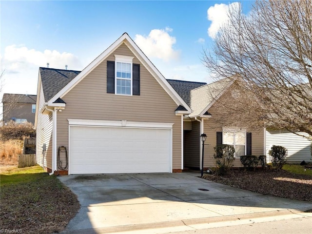 traditional-style house with a shingled roof and driveway