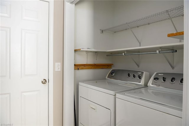 laundry area with laundry area and washing machine and clothes dryer