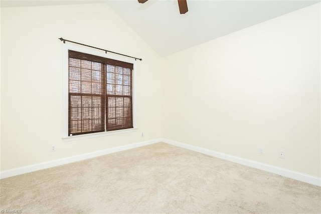 unfurnished room with carpet flooring, vaulted ceiling, baseboards, and ceiling fan