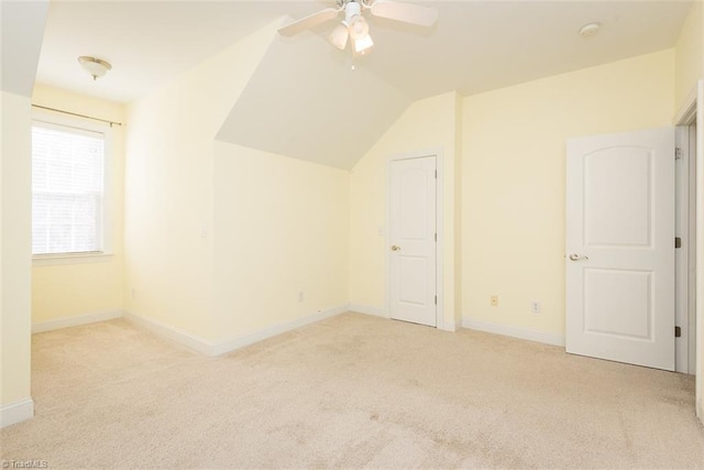 additional living space featuring a ceiling fan, carpet, lofted ceiling, and baseboards