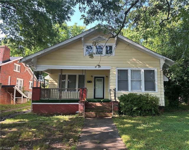 1712 E First St, Winston-Salem, NC 27101 - bungalow-style home with a porch and a front yard