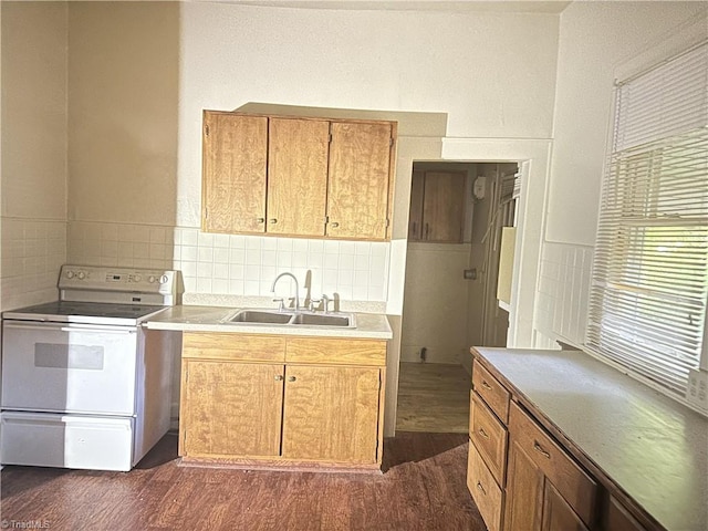 1712 E First St, Winston-Salem, NC 27101 - kitchen featuring white electric range, dark wood-style flooring, light countertops, and backsplash