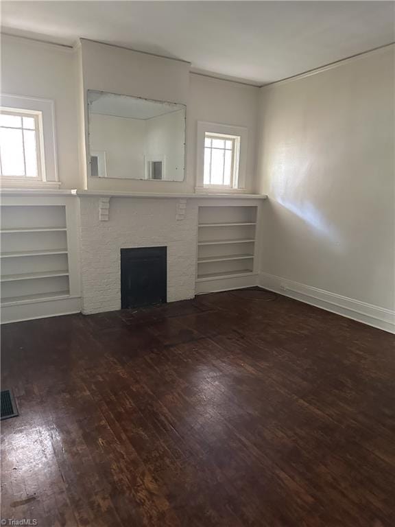 1712 E First St, Winston-Salem, NC 27101 - unfurnished living room with ornamental molding, wood finished floors, plenty of natural light, and a fireplace