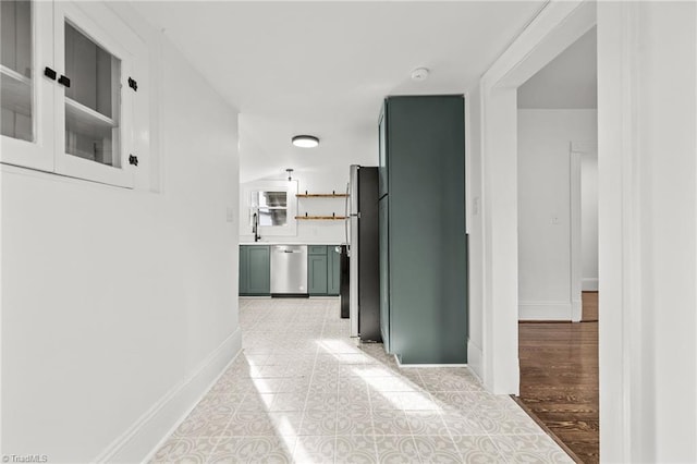 hallway with light tile patterned floors and sink