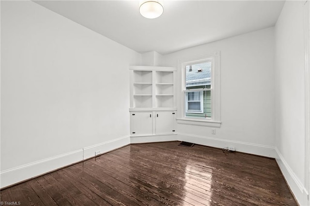 empty room with hardwood / wood-style floors