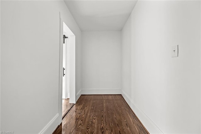 corridor with hardwood / wood-style floors