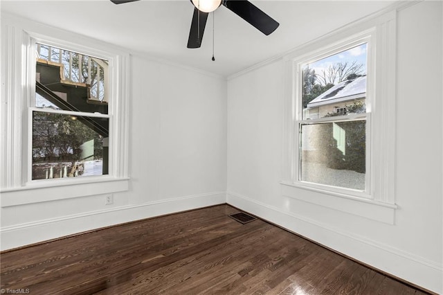 spare room with crown molding, a healthy amount of sunlight, hardwood / wood-style flooring, and ceiling fan