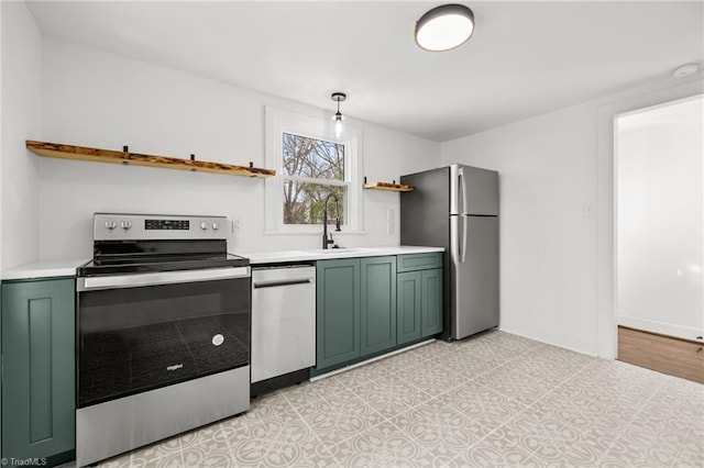 kitchen featuring green cabinets, stainless steel appliances, and sink