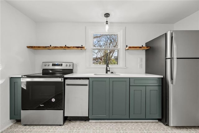 kitchen featuring green cabinets, appliances with stainless steel finishes, hanging light fixtures, and sink