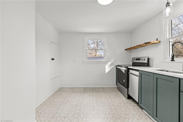 interior space with appliances with stainless steel finishes, sink, and green cabinetry