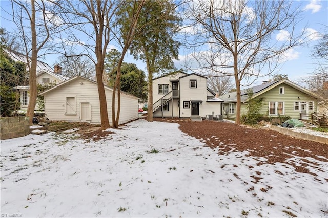 view of snow covered back of property