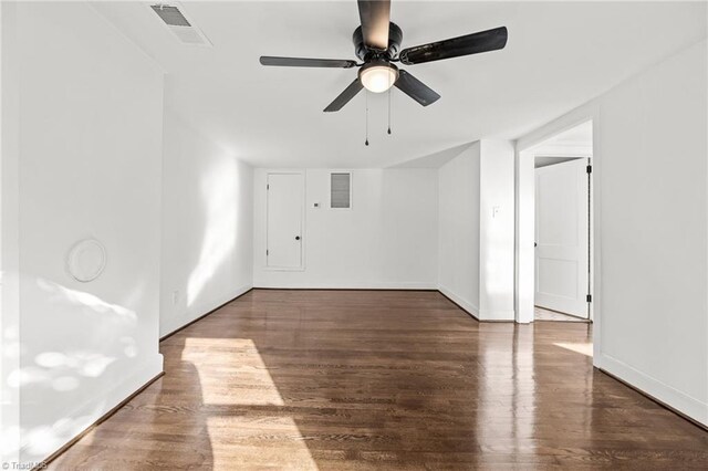 unfurnished room featuring ceiling fan and dark wood-type flooring