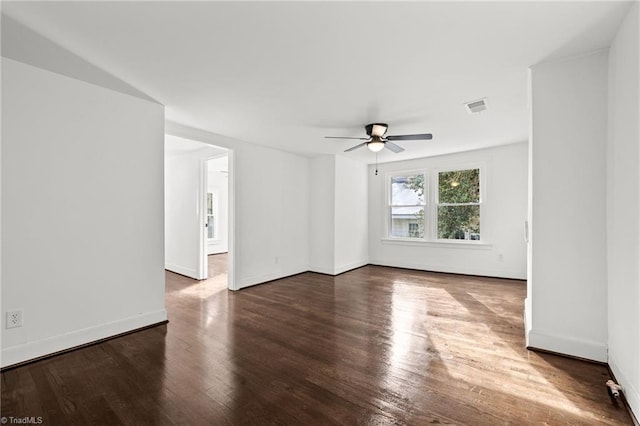 spare room with ceiling fan and dark hardwood / wood-style flooring