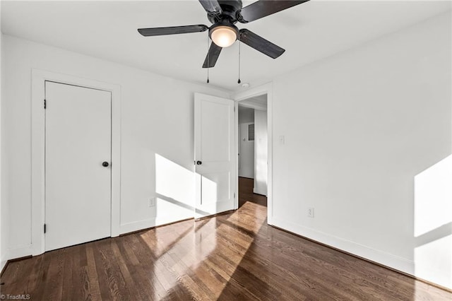 unfurnished room featuring ceiling fan and dark wood-type flooring