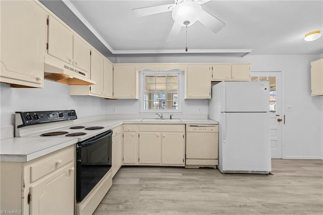 kitchen with white appliances, light countertops, under cabinet range hood, and a sink