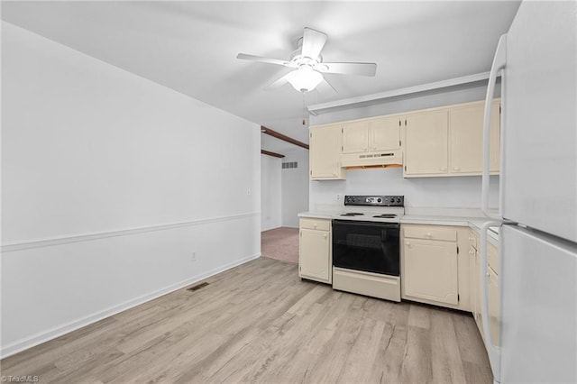 kitchen featuring under cabinet range hood, range with electric stovetop, freestanding refrigerator, light wood-style floors, and light countertops