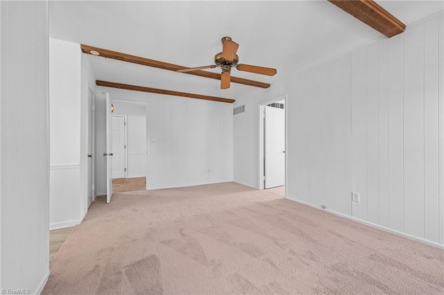 carpeted spare room featuring beam ceiling, visible vents, and a ceiling fan