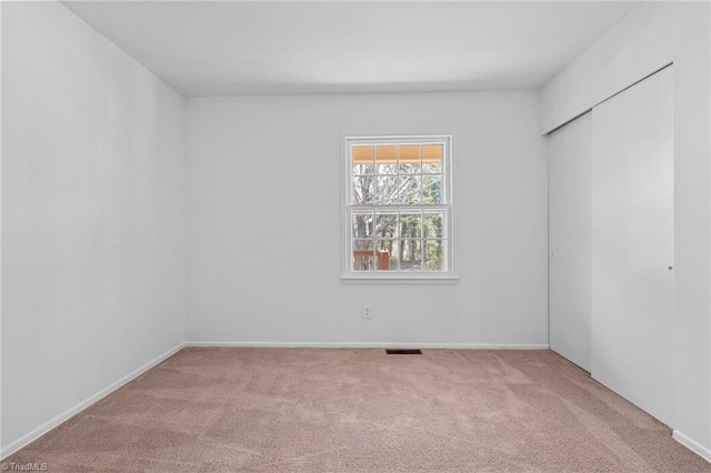 unfurnished room featuring visible vents and carpet floors