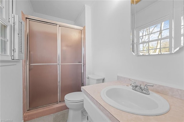 bathroom with vanity, toilet, a stall shower, and ornamental molding