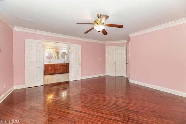 spare room featuring ornamental molding, wood finished floors, and baseboards