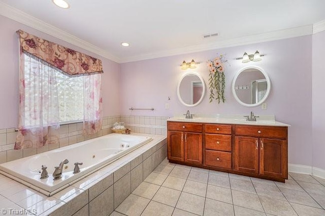 bathroom with a whirlpool tub, ornamental molding, a sink, and tile patterned floors