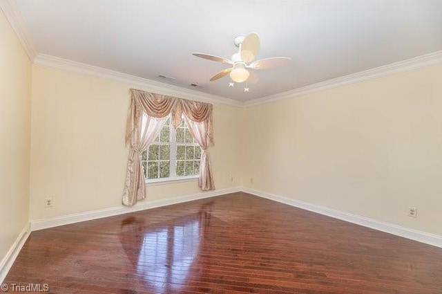 empty room featuring ceiling fan, ornamental molding, wood finished floors, and baseboards