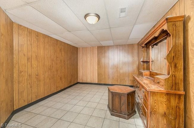 bar with visible vents, a drop ceiling, a sauna, wood walls, and light tile patterned flooring