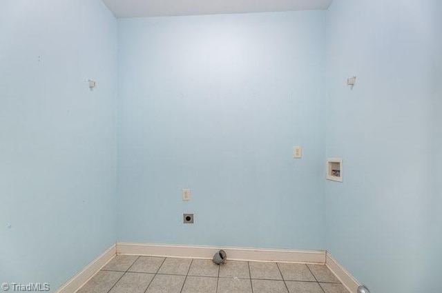 washroom with light tile patterned floors, hookup for an electric dryer, laundry area, washer hookup, and baseboards