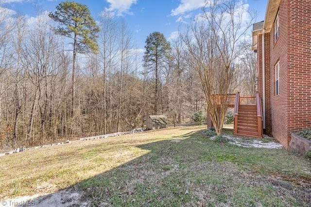 view of yard with stairs and a deck