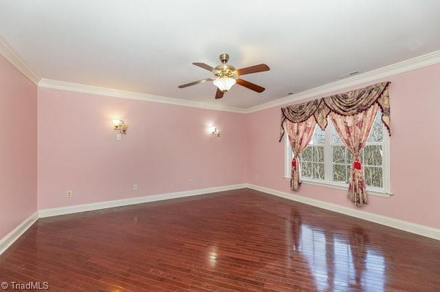 spare room with baseboards, wood finished floors, and ornamental molding