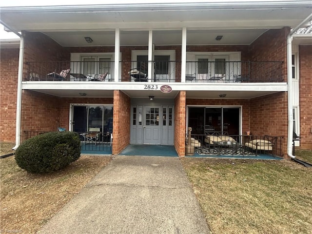 view of exterior entry with a lawn