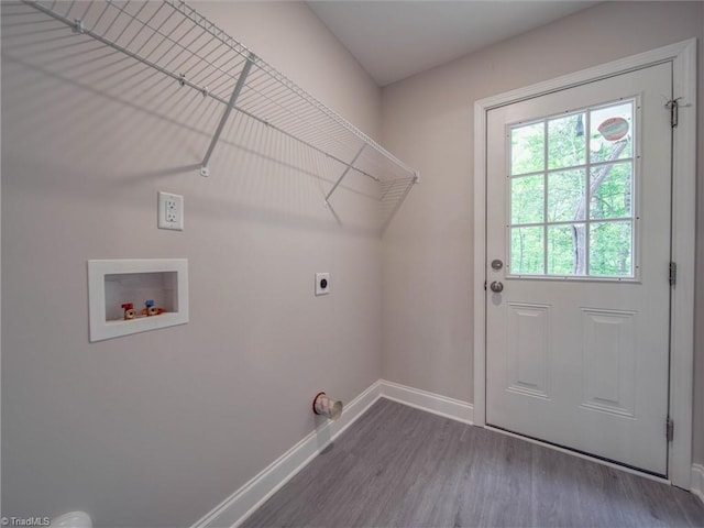 clothes washing area with electric dryer hookup, washer hookup, and dark hardwood / wood-style floors