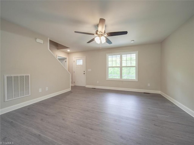 unfurnished room featuring ceiling fan and dark hardwood / wood-style flooring