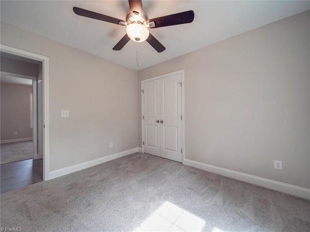 empty room featuring ceiling fan and light carpet