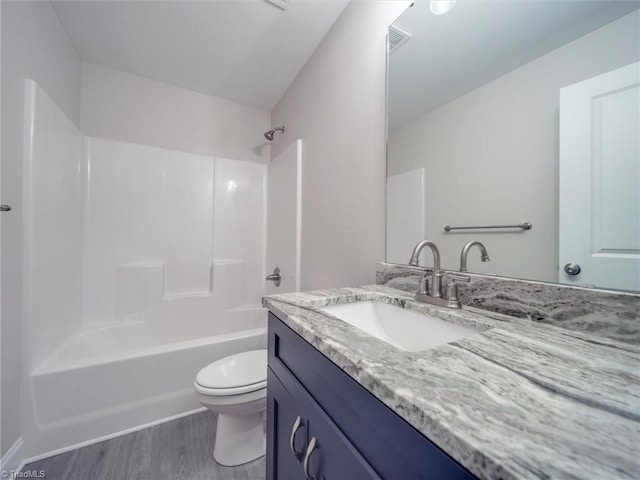 full bathroom with wood-type flooring, vanity, toilet, and  shower combination