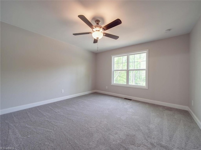 carpeted spare room with ceiling fan