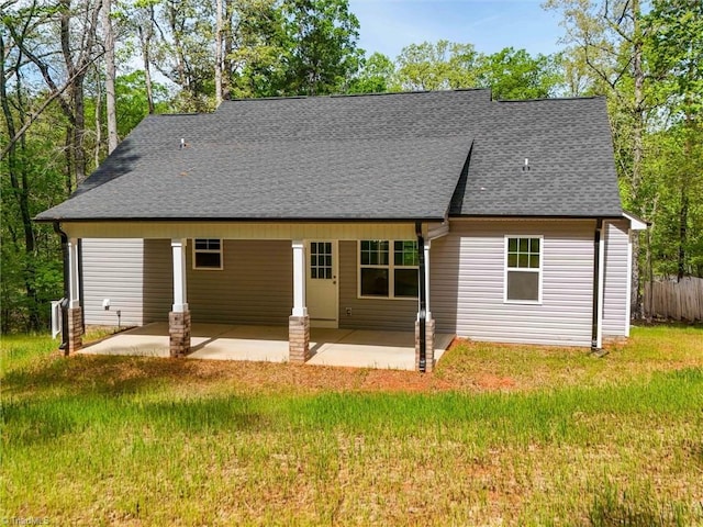 rear view of property with a patio and a lawn