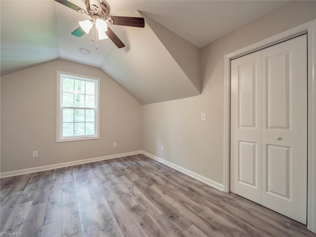 additional living space with lofted ceiling, ceiling fan, and light wood-type flooring