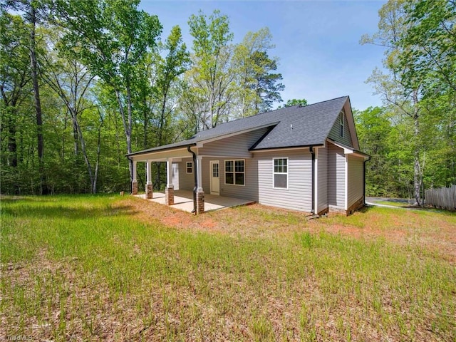 back of property featuring a patio area and a yard